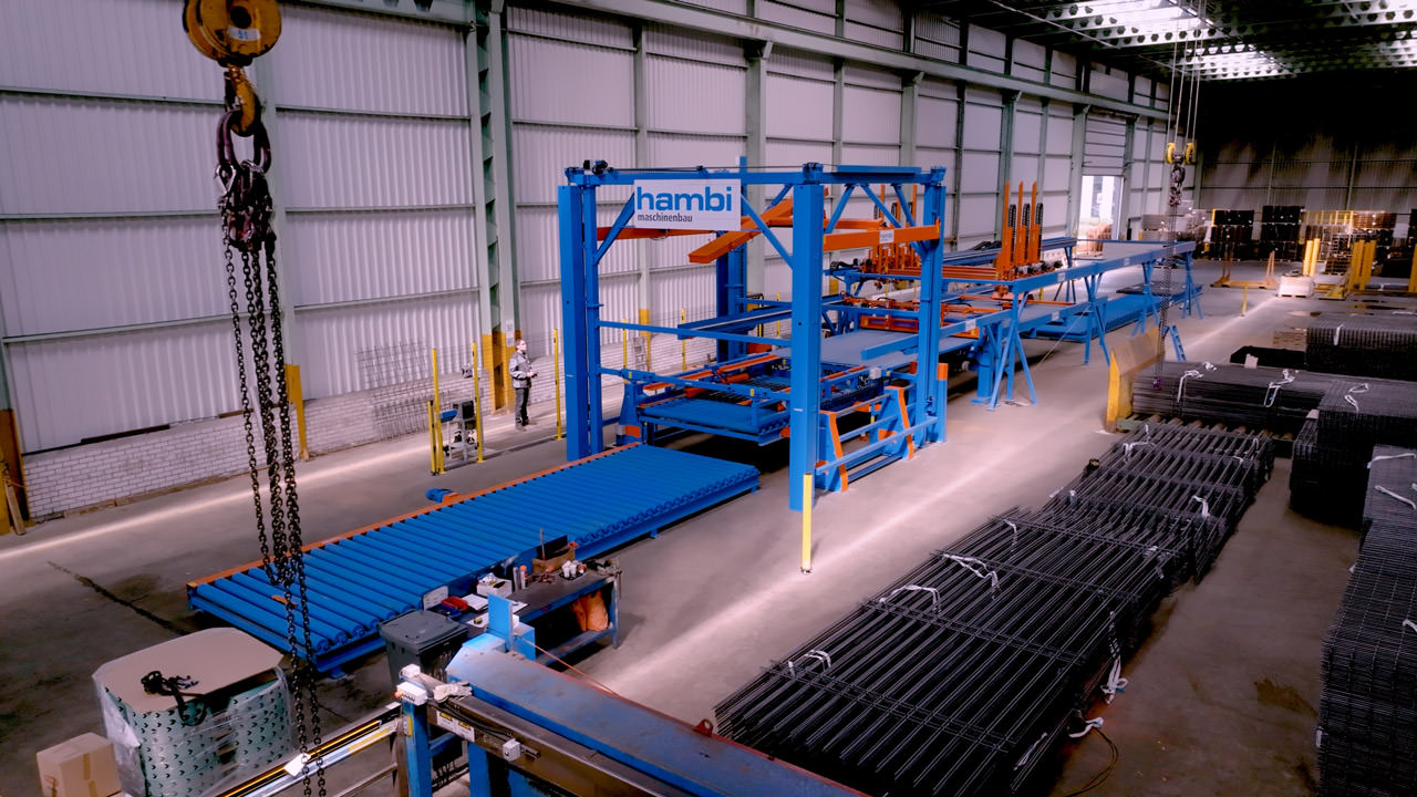 Hambi has developed a world-first system that automates the cutting, handling, and stacking of heavy reinforcing steel mesh – a task that previously required up to six human operators.